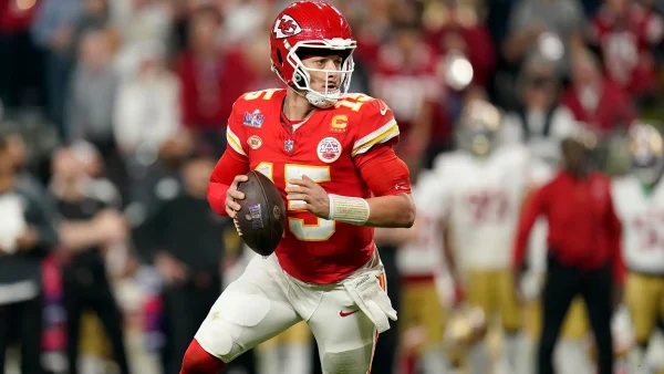 NFL player, palming the ball, in action on the field. Bet on NFL Today.